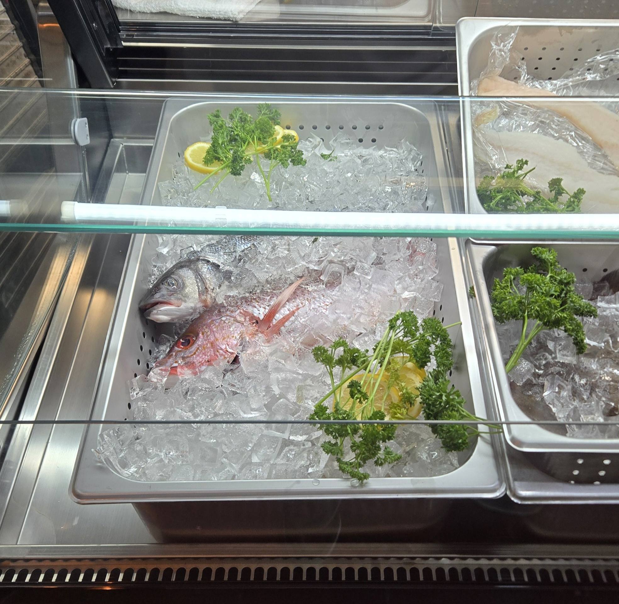 Whole fish on ice in the market case